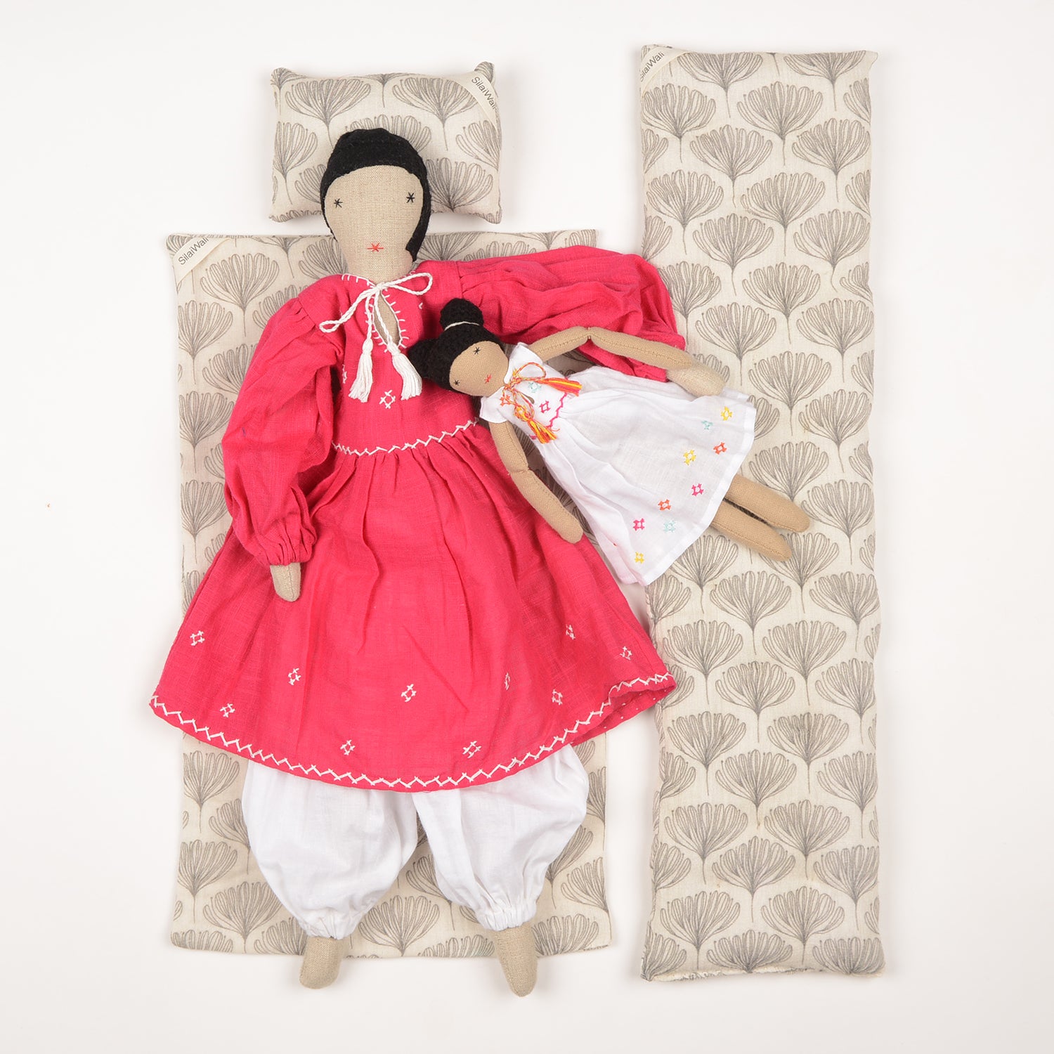 Nargis Mom&Mini dolls showcasing vibrant muslin dresses with intricate embroidery, handcrafted by Afghan artisans.